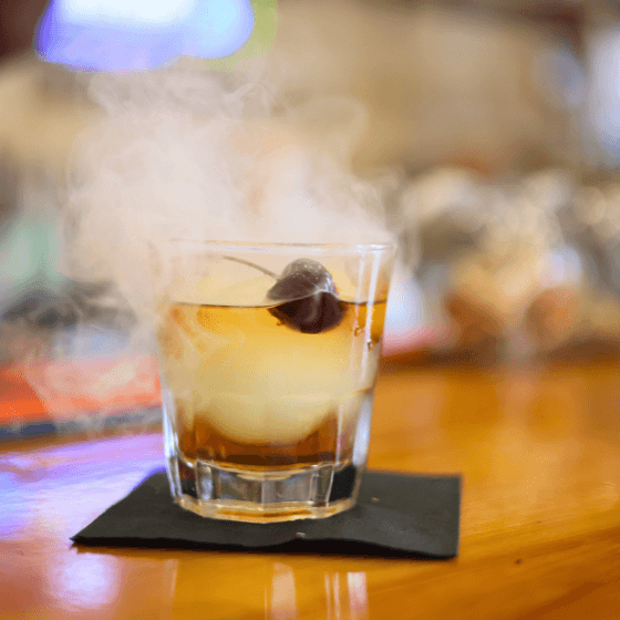 Smoked Old Fashion recipe served on a plate, by Mandez's Seafood Bar & Grill