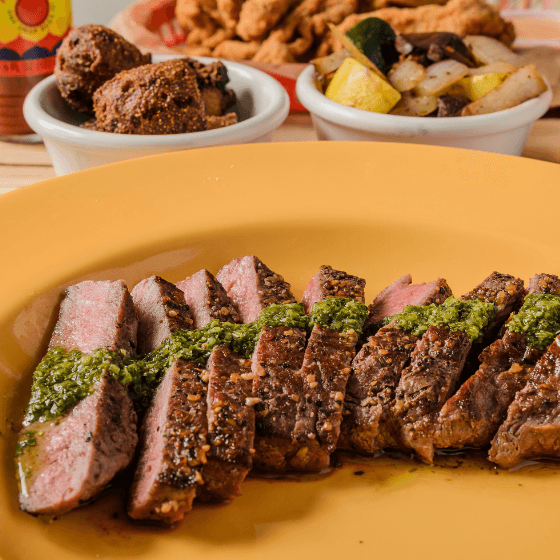 Mandez's Flat Iron Steak w/ Chimichurri recipe served on a plate, by Mandez's Seafood Bar & Grill Mandez's Flat Iron Steak w/ Chimichurri recipe served on a plate, by Mandez's Seafood Bar & Grill